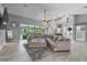 Expansive living area with sleek floors and pool view offers natural light and comfort at 7313 Crape Myrtle Way, Sarasota, FL 34241