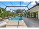 Stunning pool with screened enclosure, tropical landscaping, and ample patio space at 7313 Crape Myrtle Way, Sarasota, FL 34241