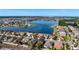 Breathtaking aerial view of a neighborhood with a serene lake and the house with lush landscaping at 1401 Parker Den Dr, Ruskin, FL 33570