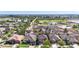 Aerial view of a neighborhood, showcasing house with lush greenery and nearby ponds at 1401 Parker Den Dr, Ruskin, FL 33570