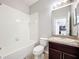 Cozy bathroom features a shower-tub combo and a granite vanity at 1401 Parker Den Dr, Ruskin, FL 33570