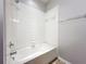 Bright bathroom features a shower and tub combination with white tile surround at 1401 Parker Den Dr, Ruskin, FL 33570