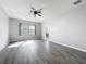 Spacious bedroom with hardwood floors, ceiling fan, and natural light at 1401 Parker Den Dr, Ruskin, FL 33570