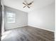 Bedroom featuring hardwood floors, a window, and a ceiling fan at 1401 Parker Den Dr, Ruskin, FL 33570
