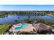 Aerial photo shows a community pool and lake views in a residential area at 1401 Parker Den Dr, Ruskin, FL 33570