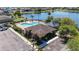 Aerial shot showcasing community pool, lounge chairs, palm trees, and picturesque lake views at 1401 Parker Den Dr, Ruskin, FL 33570