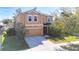 Inviting two-story home with a two-car garage, complemented by lush landscaping and a cozy front entrance at 1401 Parker Den Dr, Ruskin, FL 33570