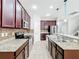 Beautiful kitchen showcasing granite counters, stainless appliances, and dark wood cabinets, centered around a functional island at 1401 Parker Den Dr, Ruskin, FL 33570
