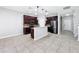 A well-equipped kitchen featuring dark wood cabinets, a functional island, and modern stainless steel appliances at 1401 Parker Den Dr, Ruskin, FL 33570