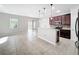Open-concept kitchen boasting dark wood cabinets, island, and stainless steel appliances, seamlessly connecting to the dining area at 1401 Parker Den Dr, Ruskin, FL 33570