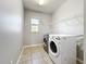 A bright laundry room with modern washer and dryer units at 1401 Parker Den Dr, Ruskin, FL 33570