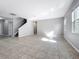 Bright living room features tile flooring, staircase, and neutral gray walls at 1401 Parker Den Dr, Ruskin, FL 33570