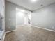 Bright living room featuring neutral walls and tile flooring leading to the staircase and doorway at 1401 Parker Den Dr, Ruskin, FL 33570