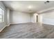A cozy living room with hardwood floors, base trim and plenty of light at 1401 Parker Den Dr, Ruskin, FL 33570
