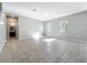 Bright living area with tile flooring, multiple windows, and an entryway leading to an adjoining bathroom at 1401 Parker Den Dr, Ruskin, FL 33570