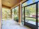 Relaxing screened porch offering a peaceful outdoor space with views of the lush green yard at 1401 Parker Den Dr, Ruskin, FL 33570