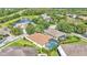 Aerial view of house featuring pool, fenced backyard and a view of the lake in the background at 15706 Starling Water Dr, Lithia, FL 33547