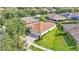 Aerial view of home featuring a well-manicured lawn and a long driveway leading to the garage at 15706 Starling Water Dr, Lithia, FL 33547