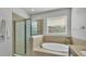 Bathroom featuring a soaking tub and glass enclosed shower at 15706 Starling Water Dr, Lithia, FL 33547