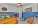 bedroom featuring blue walls, a cozy bed, and a fun play area with toys and a Lego table at 15706 Starling Water Dr, Lithia, FL 33547