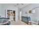 Bedroom with an organized closet, a dresser for baby essentials, and a soothing color scheme at 15706 Starling Water Dr, Lithia, FL 33547
