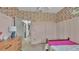 Charming bedroom featuring colorful wallpaper, a comfy bed, and stylish decor at 15706 Starling Water Dr, Lithia, FL 33547