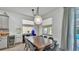 Bright dining room with a modern pendant light fixture and view of the outdoor pool at 15706 Starling Water Dr, Lithia, FL 33547
