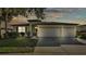 Charming home with a spacious three-car garage, neat landscaping, and inviting entryway at 15706 Starling Water Dr, Lithia, FL 33547