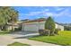 Inviting single-story home showcasing a manicured lawn and a spacious three-car garage at 15706 Starling Water Dr, Lithia, FL 33547