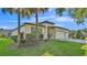 Attractive single-story home with palm trees and colorful landscaping in the front yard at 15706 Starling Water Dr, Lithia, FL 33547