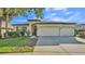 Charming one-story home with a three car garage and a well-manicured lawn with mature landscaping at 15706 Starling Water Dr, Lithia, FL 33547