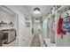 Bright hallway with drop lights, decor, access to the laundry room, and built-in cubbies at 15706 Starling Water Dr, Lithia, FL 33547