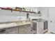 Laundry room with modern washer and dryer, folding counter, sink, storage and access to exterior at 15706 Starling Water Dr, Lithia, FL 33547