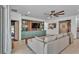 Comfortable living room with built-in shelving, a ceiling fan and a large sectional sofa at 15706 Starling Water Dr, Lithia, FL 33547