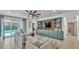 Bright living room with built-in shelving, a ceiling fan and sliding doors to an outdoor pool at 15706 Starling Water Dr, Lithia, FL 33547