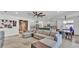 Open-concept living space featuring a sectional sofa, modern furnishings, and stylish decor at 15706 Starling Water Dr, Lithia, FL 33547
