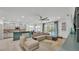 Comfortable living room with sliding glass doors to the pool area and view of the kitchen at 15706 Starling Water Dr, Lithia, FL 33547