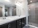 Elegant bathroom featuring a double vanity, granite countertops, and a glass-enclosed shower at 2512 58Th E Cir, Palmetto, FL 34221