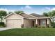 Charming single-story home with a well-manicured lawn, attached garage, and inviting front entrance at 2512 58Th E Cir, Palmetto, FL 34221