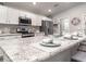 Bright kitchen featuring white cabinetry, granite countertops, stainless appliances, and island seating at 2556 58Th E Cir, Palmetto, FL 34221