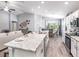 Open concept kitchen featuring a large island, modern appliances, and a dining area at 2556 58Th E Cir, Palmetto, FL 34221