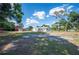 Large, open backyard with an exterior view of the buildings and the home at 4020 Mcintosh Rd, Dover, FL 33527