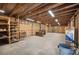 Unfinished basement with exposed wood beams and ample storage space at 4020 Mcintosh Rd, Dover, FL 33527