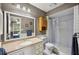 This bathroom is adorned with a large mirror and a shower and tub combo at 4020 Mcintosh Rd, Dover, FL 33527