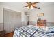 Well-lit bedroom boasts hardwood floors, a ceiling fan, and a closet for storage at 4020 Mcintosh Rd, Dover, FL 33527