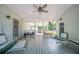 Spacious covered patio with ample seating, a ceiling fan, and views of the backyard at 4020 Mcintosh Rd, Dover, FL 33527