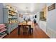 Open concept dining room and living area boasts wood floors and stylish light fixture at 4020 Mcintosh Rd, Dover, FL 33527