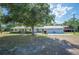Charming single-story home with a large front yard and a detached two-car garage at 4020 Mcintosh Rd, Dover, FL 33527