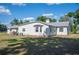 Back exterior of home, showing siding and roof, and surrounding landscape at 4020 Mcintosh Rd, Dover, FL 33527