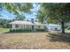 Charming single-story home with a metal roof, welcoming front porch and a manicured lawn at 4020 Mcintosh Rd, Dover, FL 33527